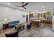 An open floor plan living and kitchen area with gray plank flooring at 7508 W Short Rd, Plant City, FL 33565