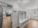 Mudroom with storage and coat rack, with view of living area and laundry at 7508 W Short Rd, Plant City, FL 33565