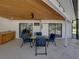 Covered patio with ceiling fan, seating, and a dry bar, providing a great entertaining space at 7508 W Short Rd, Plant City, FL 33565