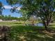 Scenic shot of a tranquil pond surrounded by lush greenery and mature trees at 7508 W Short Rd, Plant City, FL 33565
