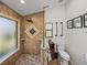A tile shower features stone floors, a window, and a decorative mosaic tile detail at 7508 W Short Rd, Plant City, FL 33565