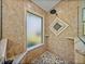 A tile shower features stone floors, a window, and a mosaic tile detail at 7508 W Short Rd, Plant City, FL 33565