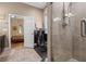 Bathroom with glass shower door, exercise equipment, and a view into the primary bedroom at 7615 S Fitzgerald St, Tampa, FL 33616