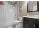 Bathroom with a combination tub and shower, pedestal sink, and neutral color scheme at 7615 S Fitzgerald St, Tampa, FL 33616