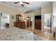 Bedroom with hardwood floors, a ceiling fan, and doors to ensuite bathroom and living room at 7615 S Fitzgerald St, Tampa, FL 33616