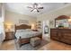 Well-lit bedroom with a ceiling fan, hardwood floors, and traditional furnishings at 7615 S Fitzgerald St, Tampa, FL 33616