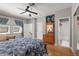 Bedroom with hardwood floors, a ceiling fan, and ensuite bathroom at 7615 S Fitzgerald St, Tampa, FL 33616