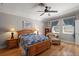 Bedroom with a ceiling fan, hardwood floors, and matching nightstands at 7615 S Fitzgerald St, Tampa, FL 33616