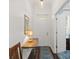 Inviting entryway with dark hardwood floors, console table with lamp, and white front door at 7615 S Fitzgerald St, Tampa, FL 33616