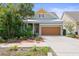 Charming single-Gathering home with a well-manicured lawn, lush landscaping, and attached two-car garage at 7615 S Fitzgerald St, Tampa, FL 33616