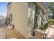 Exterior side view of the home featuring green awnings, rock groundcover and paver walkway at 7615 S Fitzgerald St, Tampa, FL 33616