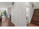 Hallway leading to staircase and laundry room, blending functionality with stylish design at 7615 S Fitzgerald St, Tampa, FL 33616