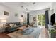 Bright living room features a comfortable sofa, stylish decor, and sliding glass doors to the outdoor space at 7615 S Fitzgerald St, Tampa, FL 33616