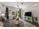 Spacious living room featuring a comfortable sofa, stylish decor, and entertainment center at 7615 S Fitzgerald St, Tampa, FL 33616