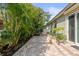 Paver patio with privacy landscaping, offering an inviting outdoor living space at 7615 S Fitzgerald St, Tampa, FL 33616