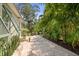 Paver patio with mature landscaping, offering a private outdoor living space at 7615 S Fitzgerald St, Tampa, FL 33616