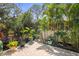 Charming outdoor patio area, complete with lush landscaping and brick pavers at 7615 S Fitzgerald St, Tampa, FL 33616