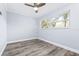 Bright bedroom featuring wood-look floors, a double window providing lots of natural light, and simple white shelving at 8238 30Th N Ave, St Petersburg, FL 33710