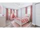 Charming bedroom with pink decor, a white bed, accent furniture, and wood-look floors at 8238 30Th N Ave, St Petersburg, FL 33710