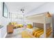 Shared bedroom with bunkbeds, bright yellow accents, wood-look floors, and natural light at 8238 30Th N Ave, St Petersburg, FL 33710
