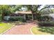 Charming home with mature landscaping and a brick walkway leading to the front entrance at 8238 30Th N Ave, St Petersburg, FL 33710