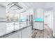 Bright kitchen with an expansive island, stainless steel appliances, and a striking blue backsplash at 8238 30Th N Ave, St Petersburg, FL 33710