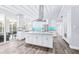 Bright kitchen with an expansive island, stainless steel appliances, and a striking blue backsplash at 8238 30Th N Ave, St Petersburg, FL 33710