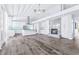 A stylish open-concept kitchen with marble fireplace, hardwood floor, and white cabinets at 8238 30Th N Ave, St Petersburg, FL 33710