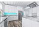 Bright kitchen with an expansive island, stainless steel appliances, and a striking blue backsplash at 8238 30Th N Ave, St Petersburg, FL 33710