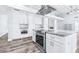 Modern kitchen featuring sleek appliances, granite counters, an island and hardwood flooring at 8238 30Th N Ave, St Petersburg, FL 33710