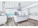 Bright kitchen with an expansive island, stainless steel appliances, and a striking blue backsplash at 8238 30Th N Ave, St Petersburg, FL 33710