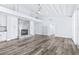 Bright living room with hardwood floors, a sleek fireplace, and modern built-in shelving for stylish storage at 8238 30Th N Ave, St Petersburg, FL 33710
