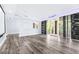 Sunlit living room boasts hardwood floors, white trim, and sliding glass doors to the exterior at 8238 30Th N Ave, St Petersburg, FL 33710