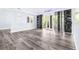 Open living room with hardwood floors, white walls, and sliding glass doors overlooking the yard at 8238 30Th N Ave, St Petersburg, FL 33710