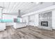 Open living space with hardwood floors, modern kitchen, fireplace, and expansive island for entertaining at 8238 30Th N Ave, St Petersburg, FL 33710