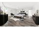 Main bedroom with a gray bed, black accent furniture, art, and plush rugs on wood floors at 8238 30Th N Ave, St Petersburg, FL 33710
