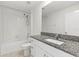 Bathroom featuring a sleek vanity with granite countertop and a shower-over-tub at 8598 Parsons Hill Blvd, Wesley Chapel, FL 33545