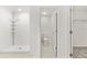 This bathroom features a standing shower, toilet, and walk-in closet with white walls and tile flooring at 8598 Parsons Hill Blvd, Wesley Chapel, FL 33545