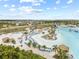 A beautiful sandy beach with sun loungers and palm trees on the edge of a blue lagoon at 8598 Parsons Hill Blvd, Wesley Chapel, FL 33545