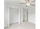 Bedroom showcasing neutral carpet, ceiling fan, and a closet with open doors at 8598 Parsons Hill Blvd, Wesley Chapel, FL 33545
