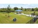 Fenced community dog park featuring a covered seating area, play equipment, and green space for pets at 8598 Parsons Hill Blvd, Wesley Chapel, FL 33545