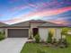 Charming single-story home featuring a two-car garage, landscaped front yard, and a covered entryway at 8598 Parsons Hill Blvd, Wesley Chapel, FL 33545
