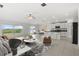 Bright open-concept living area flowing into a modern kitchen with stainless steel appliances and backyard views at 8598 Parsons Hill Blvd, Wesley Chapel, FL 33545