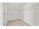A spacious walk-in closet featuring white wire shelving and plush neutral carpet at 8598 Parsons Hill Blvd, Wesley Chapel, FL 33545
