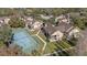 Aerial view of condo community highlighting tennis court, landscaped grounds, and building exteriors at 8724 Mallard Reserve Dr # 101, Tampa, FL 33614