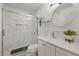 Contemporary bathroom features a marble shower with glass doors, sleek vanity, and a round mirror at 8724 Mallard Reserve Dr # 101, Tampa, FL 33614