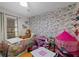 Bright bedroom features playful wallpaper, a cozy bed, toys, and a window for natural light at 8724 Mallard Reserve Dr # 101, Tampa, FL 33614