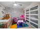 ' bedroom with playful wallpaper, comfortable bed, toys, and sliding glass doors for ample light at 8724 Mallard Reserve Dr # 101, Tampa, FL 33614