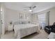 Calm bedroom with a ceiling fan, queen bed, crib, and a view of an adjacent room at 8724 Mallard Reserve Dr # 101, Tampa, FL 33614