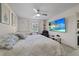 Inviting bedroom with a queen bed, TV, ceiling fan, and a comfortable reading chair at 8724 Mallard Reserve Dr # 101, Tampa, FL 33614